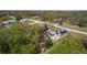 Aerial shot featuring solar panels, screened-in pool, and landscaped backyard at 377 Ed Douglas Rd, Groveland, FL 34736