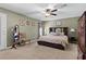 Spacious main bedroom with a ceiling fan, carpet flooring, and a walk-in closet at 377 Ed Douglas Rd, Groveland, FL 34736