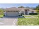 Charming single-story home with well-manicured lawn and a two-car garage at 377 Ed Douglas Rd, Groveland, FL 34736