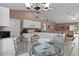 Bright eat-in kitchen featuring white cabinetry, granite countertops, and modern appliances with dining area at 377 Ed Douglas Rd, Groveland, FL 34736