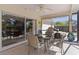 Outdoor living space featuring a screened-in patio with a table and chairs near a sliding glass door at 377 Ed Douglas Rd, Groveland, FL 34736