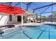 Backyard view of pool and outdoor living space with patio area and screened-in porch at 377 Ed Douglas Rd, Groveland, FL 34736