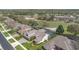 Scenic aerial view of a home with a screened lanai, mature landscaping, and golf course views at 4256 Fawn Meadows Cir, Clermont, FL 34711