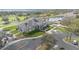 Aerial shot of clubhouse amenities including a pool, golf course, and parking at 4256 Fawn Meadows Cir, Clermont, FL 34711