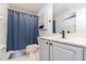 Well-lit bathroom featuring a shower with a blue curtain and a clean, modern sink at 4256 Fawn Meadows Cir, Clermont, FL 34711