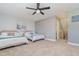 Spacious bedroom with two beds, soft carpet, and neutral tones, creating a relaxing atmosphere at 4256 Fawn Meadows Cir, Clermont, FL 34711