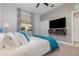 Relaxing bedroom featuring a TV, plush carpet, and large window with colorful patterned curtains at 4256 Fawn Meadows Cir, Clermont, FL 34711