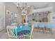 A dining room adjacent to the kitchen featuring white chairs, a blue tablecloth, and tile floors at 4256 Fawn Meadows Cir, Clermont, FL 34711