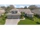 Beautifully landscaped home featuring a three-car garage and inviting curb appeal at 4256 Fawn Meadows Cir, Clermont, FL 34711