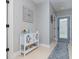 Hallway featuring light grey walls, tile floors, blue door, and built-in shelving unit at 4256 Fawn Meadows Cir, Clermont, FL 34711