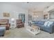 A living room area showing comfortable seating, view to the backyard, and chandelier at 4256 Fawn Meadows Cir, Clermont, FL 34711