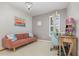 Inviting office featuring a pink couch, a chandelier, and a desk by a window at 4256 Fawn Meadows Cir, Clermont, FL 34711