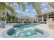 Inviting screened-in pool with lush landscaping, lounge chairs, and hot tub at 4256 Fawn Meadows Cir, Clermont, FL 34711