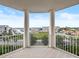 Balcony overlooking the marina with stunning views and white columns at 4620 Riverwalk Village Ct # 7505, Ponce Inlet, FL 32127