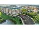 Condo building with mature landscaping, pond views, and parking at 4620 Riverwalk Village Ct # 7505, Ponce Inlet, FL 32127