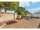 Backyard area featuring lounge chairs with low-maintenance desert landscaping and tropical accents at 483 Cammarano Pl, The Villages, FL 32162