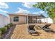 View of backyard showing an enclosed patio with lounge chairs overlooking the lawn and landscaping at 483 Cammarano Pl, The Villages, FL 32162