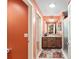 Hallway view of a bathroom featuring a shower, vanity, and neutral color scheme at 483 Cammarano Pl, The Villages, FL 32162