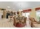 Dining area with adjacent kitchen, living area, and outdoor patio at 483 Cammarano Pl, The Villages, FL 32162