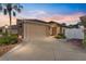 Charming single Gathering home with a two-car garage, mature landscaping and beautiful evening sky at 483 Cammarano Pl, The Villages, FL 32162