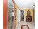 Inviting foyer with decorative rug, tiled flooring, wood credenza, and open floor plan at 483 Cammarano Pl, The Villages, FL 32162