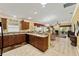 Spacious kitchen with bar seating leading to dining and living areas at 483 Cammarano Pl, The Villages, FL 32162