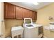 Laundry room with full-sized washer and dryer and built-in upper cabinets at 483 Cammarano Pl, The Villages, FL 32162