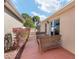 Exterior view of the side yard featuring wicker seating, flowering plants and privacy at 483 Cammarano Pl, The Villages, FL 32162