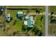 An aerial view of a home with a well-manicured lawn, driveway, and lush landscaping at 4940 County Road 134B, Wildwood, FL 34785
