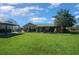 Serene backyard showcasing a lush lawn, gazebo, and covered patio, creating an ideal outdoor retreat at 4940 County Road 134B, Wildwood, FL 34785