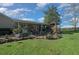Inviting backyard with a covered patio, gazebo, and lush landscaping, perfect for entertaining and relaxing at 4940 County Road 134B, Wildwood, FL 34785