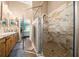 Modern bathroom with a glass-enclosed shower and double sink vanity at 4940 County Road 134B, Wildwood, FL 34785
