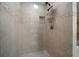 Modern shower with tile surround, glass door, rainfall shower head and recessed storage at 4940 County Road 134B, Wildwood, FL 34785
