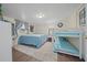 Comfortable bedroom featuring a bed, bunk beds, window and soft, blue accents at 4940 County Road 134B, Wildwood, FL 34785