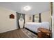 Bedroom with hardwood floors, neutral paint, window and gray curtains at 4940 County Road 134B, Wildwood, FL 34785
