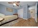 Bedroom with a full-size bed, wood floors, closet space, and access to an en-suite bathroom at 4940 County Road 134B, Wildwood, FL 34785