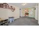 Bonus room featuring neutral paint, carpet, and access to the living room at 4940 County Road 134B, Wildwood, FL 34785