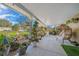 Inviting covered patio with ample seating, lush plants, and tranquil outdoor living space at 4940 County Road 134B, Wildwood, FL 34785