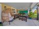 Cozy covered patio with comfortable seating, decorative plants, and stylish decor at 4940 County Road 134B, Wildwood, FL 34785