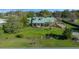 A picturesque view of the home showcasing mature landscaping, and beautiful lawn at 4940 County Road 134B, Wildwood, FL 34785