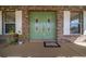 Charming home exterior featuring a brick facade, double doors, and decorative shutters, adding to its curb appeal at 4940 County Road 134B, Wildwood, FL 34785