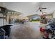 A detached garage with open overhead doors and ample storage at 4940 County Road 134B, Wildwood, FL 34785