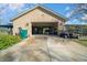 A detached garage with ample space for vehicles, golf carts, and storage at 4940 County Road 134B, Wildwood, FL 34785
