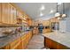 Well-equipped kitchen featuring wooden cabinets, granite countertops, and stainless steel appliances at 4940 County Road 134B, Wildwood, FL 34785