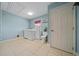 Bright laundry room with tile flooring, washer, dryer, sink, and toilet for convenience at 4940 County Road 134B, Wildwood, FL 34785