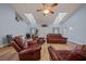 Bright living room showcasing a high ceiling, wood floors, and comfortable leather furniture at 4940 County Road 134B, Wildwood, FL 34785
