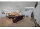 Spacious living room featuring wood floors, comfortable seating, and lots of natural light at 4940 County Road 134B, Wildwood, FL 34785