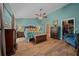 Large bedroom with a ceiling fan, ensuite bathroom and a walk-in closet at 4940 County Road 134B, Wildwood, FL 34785