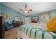 Main bedroom with wooden floors, a ceiling fan, walk-in closet, and ensuite bathroom access at 4940 County Road 134B, Wildwood, FL 34785