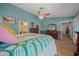 Stylish main bedroom featuring vaulted ceilings, wood floors, and an ensuite bathroom at 4940 County Road 134B, Wildwood, FL 34785